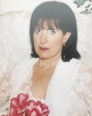 Kalindi photo 15 - sitting dressed in white with red flowers (8 X 10 and 5 x 7)